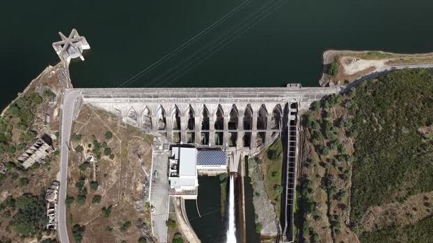 Aerial view of Barragem da Pracana with water discharge Portugal.