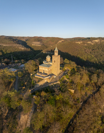 Aerial view of Tsarevets Fortress a historic medieval stronghold with its iconic church and stone walls set atop a hill in Veliko Tarnovo Veliko Tarnovo Bulgaria. Aerial view of Tsarevets Fortress a historic medieval stronghold with its iconic church and stone walls set atop a hill in Veliko Tarnovo Veliko Tarnovo Bulgaria.