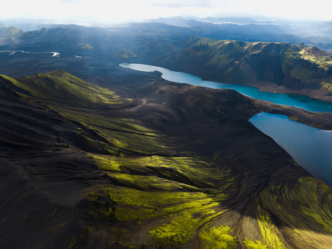 Aerial view of glacial rivers cutting through the rugged moss covered highlands a tapestry of emerald and charcoal under the vast Icelandic sky Skaftárhreppur Iceland. Aerial view of glacial rivers cutting through the rugged moss covered highlands a tapestry of emerald and charcoal under the vast Icelandic sky Skaftárhreppur Iceland.
