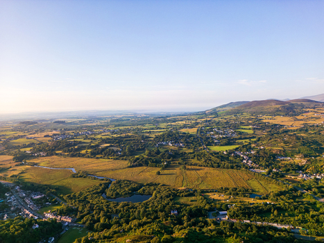 Aerial view of the village of Cwm y glo with its rolling green hills lush fields and a winding river Cwm y glo Wales United Kingdom. Aerial view of the village of Cwm y glo with its rolling green hills lush fields and a winding river Cwm y glo Wales United Kingdom.