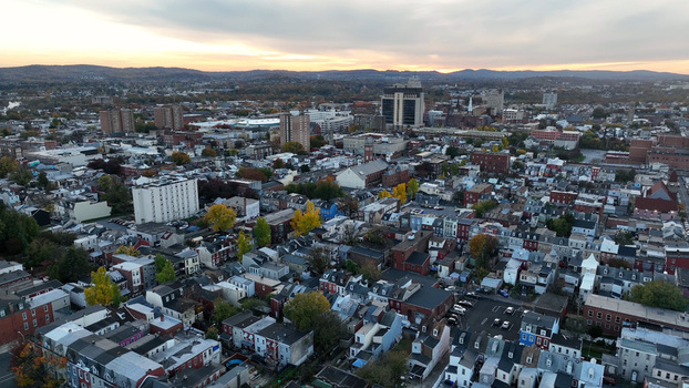 Aerial view of the urban landscape of Reading during autumn featuring dense residential and commercial architecture colorful fall foliage and a sunset sky Reading Pennsylvania United States.