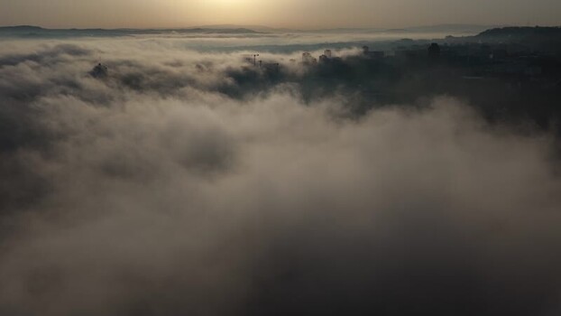 Aerial view of buildings emerging from fog Portugal.