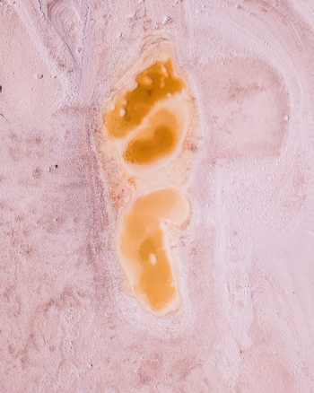 Aerial view of yellow salt pool in pink dried salt lake Lake Hart Island Lagoon Woomera South Australia