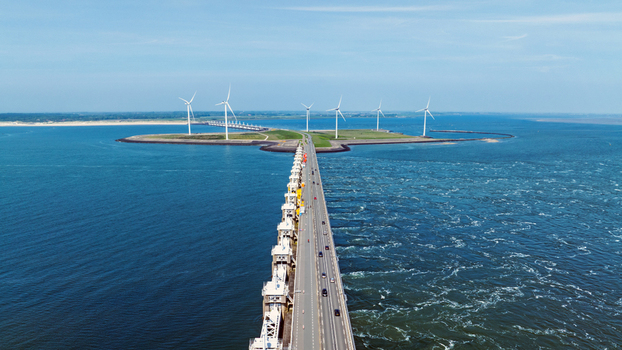 Aerial view of the Eastern Scheldt Storm Surge Barrier with wind turbines on the artificial island surrounded by the North Sea Vrouwenpolder Zeeland Netherlands. Aerial view of the Eastern Scheldt Storm Surge Barrier with wind turbines on the artificial island surrounded by the North Sea Vrouwenpolder Zeeland Netherlands.