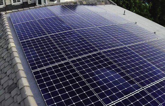 Aerial view of a mounted solar photovoltaic array on a residential roof in Los Angeles CA United States.