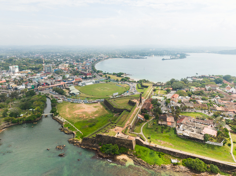 Aerial view of the historic Galle Fort and the international cricket stadium overlooking the bay and city skyline in Galle Southern Province Sri Lanka. Aerial view of the historic Galle Fort and the international cricket stadium overlooking the bay and city skyline in Galle Southern Province Sri Lanka.