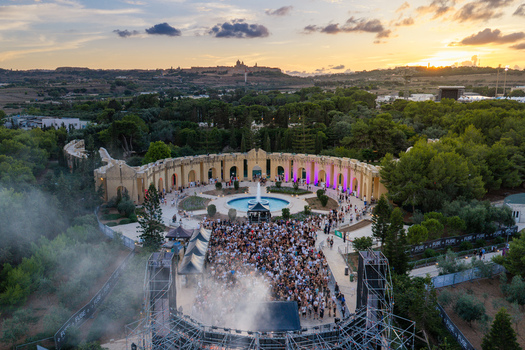 Attard Malta 20 September 2026 Aerial view of Park Nazzjonali Ta Qali with a large crowd at an outdoor music festival during sunset featuring the historic Mdina skyline. Attard Malta 20 September 2026 Aerial view of Park Nazzjonali Ta Qali with a large crowd at an outdoor music festival during sunset featuring the historic Mdina skyline.