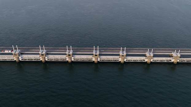 Aerial view of the Eastern Scheldt Storm Surge Barrier with its massive concrete piers and steel gates spanning the water in Vrouwenpolder Zeeland Netherlands. Aerial view of the Eastern Scheldt Storm Surge Barrier with its massive concrete piers and steel gates spanning the water in Vrouwenpolder Zeeland Netherlands.
