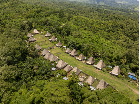 Aerial view of Kampung Adat Belaraghi with its traditional thatched roof houses nestled in a lush green forest in Kecamatan Aimere Nusa Tenggara Timur Indonesia. Aerial view of Kampung Adat Belaraghi with its traditional thatched roof houses nestled in a lush green forest in Kecamatan Aimere Nusa Tenggara Timur Indonesia.