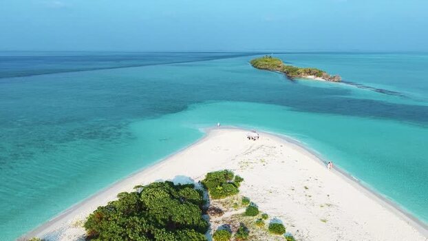 Aerial view of a tropical sandbar and turquoise waters Maldives.