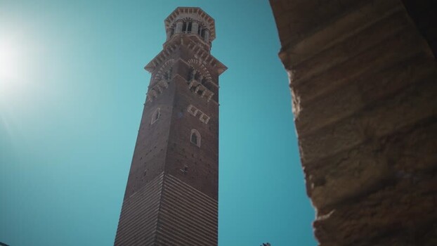 View of the historic Lamberti Tower against a clear blue sky Italy. View of the historic Lamberti Tower against a clear blue sky Italy.