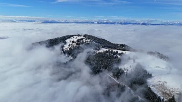 Aerial view of Schockl mountain peak above clouds Austria. Aerial view of Schockl mountain peak above clouds Austria.