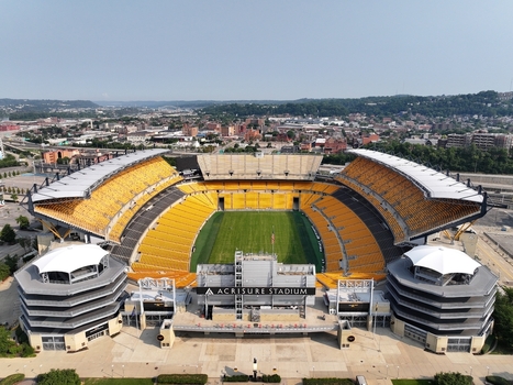 Pittsburgh United States 26 July 2026 Aerial view of Acrisure Stadium in Pittsburgh Pennsylvania featuring yellow seating green field and surrounding urban landscape.
