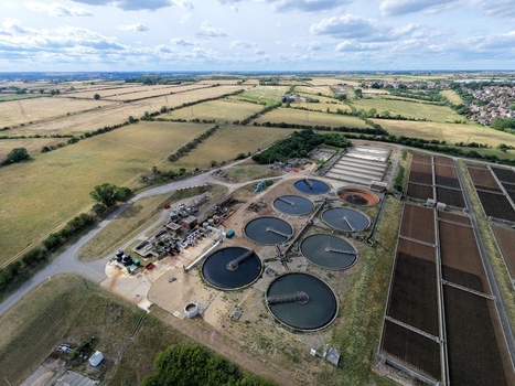 Aerial view of Broadholme water recycling centre featuring circular sedimentation tanks and rectangular treatment beds surrounded by rural fields in Rushden England United Kingdom. Aerial view of Broadholme water recycling centre featuring circular sedimentation tanks and rectangular treatment beds surrounded by rural fields in Rushden England United Kingdom.