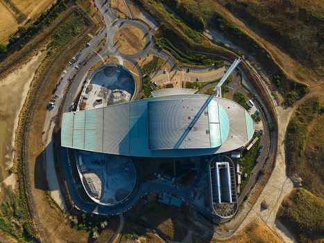 Aerial view of the Energy Recovery Facility a biomass to electricity plant with a tall chimney surrounding roads and a roundabout in Bicester England United Kingdom.