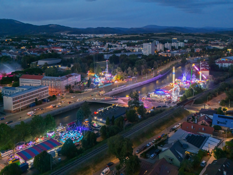 Aerial view of Radvansky jarmok carnival rides illuminated at night along the Hron river in Banska Bystrica Banskobystricky kraj Slovakia.