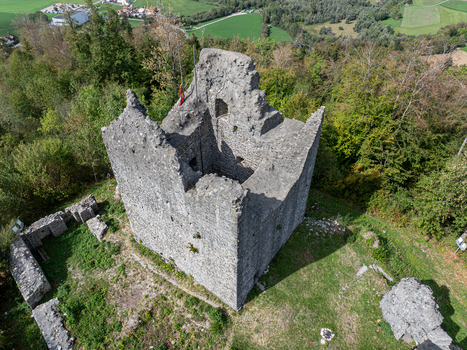 Aerial view of the historic stone ruins of Burg Montsalvens surrounded by lush green forest and rolling hills in Broc Fribourg Switzerland. Aerial view of the historic stone ruins of Burg Montsalvens surrounded by lush green forest and rolling hills in Broc Fribourg Switzerland.