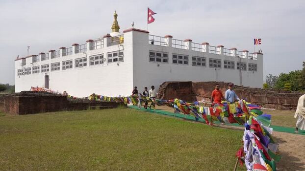View of the Maya Devi Temple with prayer flags in Lumbini Nepal.