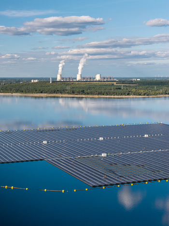 Aerial view of the floating solar park on Cottbuser Ostsee with the Janschwalde Power Plant in the background showcasing the energy transition in Cottbus Brandenburg Germany. Aerial view of the floating solar park on Cottbuser Ostsee with the Janschwalde Power Plant in the background showcasing the energy transition in Cottbus Brandenburg Germany.