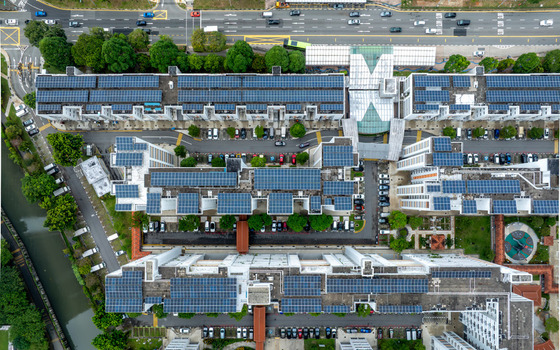 Aerial view of Whampoa River and HDB apartment blocks featuring rooftop solar panels with surrounding roads parking areas and lush greenery in Singapore Singapore. Aerial view of Whampoa River and HDB apartment blocks featuring rooftop solar panels with surrounding roads parking areas and lush greenery in Singapore Singapore.