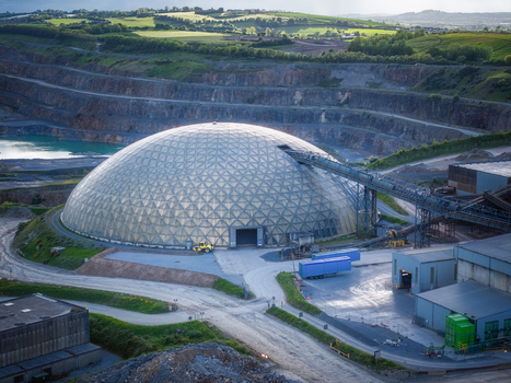 Aerial view of the Irish Cement Ltd facility featuring a large geodesic dome and an open pit limestone quarry surrounded by green hills in Drogheda County Louth Ireland. Aerial view of the Irish Cement Ltd facility featuring a large geodesic dome and an open pit limestone quarry surrounded by green hills in Drogheda County Louth Ireland.