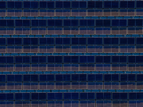 Aerial view of floating solar farm with blue panels arranged in a geometric grid over water Bensheim Hessen Germany. Aerial view of floating solar farm with blue panels arranged in a geometric grid over water Bensheim Hessen Germany.