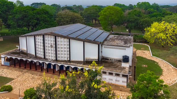 Aerial view of Achimota School featuring a modern building with solar panels on the roof surrounded by lush green trees and stone pathways in Achimota Greater Accra Region Ghana. Aerial view of Achimota School featuring a modern building with solar panels on the roof surrounded by lush green trees and stone pathways in Achimota Greater Accra Region Ghana.