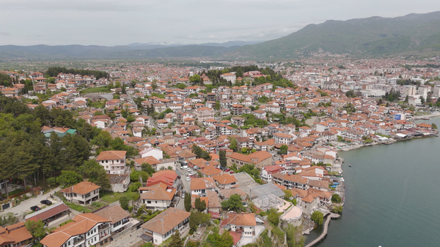 Aerial view of the historic town of Ohrid featuring traditional red tiled rooftops narrow streets and the scenic shoreline of Lake Ohrid in Ohrid Municipality of Ohrid North Macedonia. Aerial view of the historic town of Ohrid featuring traditional red tiled rooftops narrow streets and the scenic shoreline of Lake Ohrid in Ohrid Municipality of Ohrid North Macedonia.