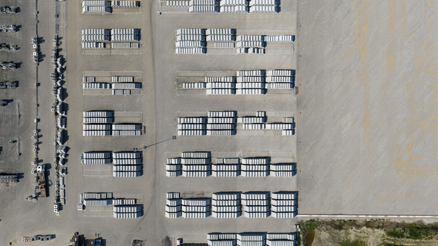 Aerial view of neatly stacked concrete blocks and prefabricated building materials in an industrial storage yard with a truck parked nearby Oosterhout North Brabant Netherlands. Aerial view of neatly stacked concrete blocks and prefabricated building materials in an industrial storage yard with a truck parked nearby Oosterhout North Brabant Netherlands.
