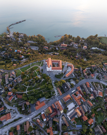Aerial view of Tihany Abbey a historic Benedictine monastery surrounded by lush gardens and the town overlooking Lake Balaton in Tihany Hungary. Aerial view of Tihany Abbey a historic Benedictine monastery surrounded by lush gardens and the town overlooking Lake Balaton in Tihany Hungary.