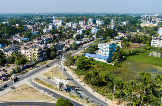 Aerial view of the urban landscape featuring residential buildings roads and green spaces in Rajshahi Rajshahi Division Bangladesh.