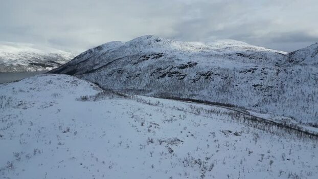 Aerial view of snow covered mountains on Kvaloya island Norway.