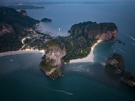 Aerial view of dramatic limestone cliffs meet the turquoise sea creating a stunning contrast of textures and tones Railay Beach Thailand. Aerial view of dramatic limestone cliffs meet the turquoise sea creating a stunning contrast of textures and tones Railay Beach Thailand.