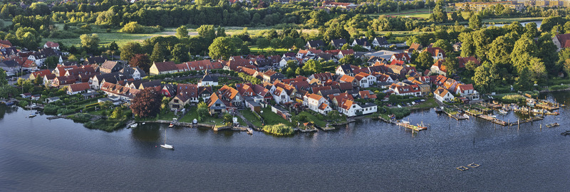 Schleswig Schleswig Holstein Germany 01 July 2026 Aerial view of the Holm fishing village and St Johannis kloster along the Schlei fjord with historic houses and lush greenery.