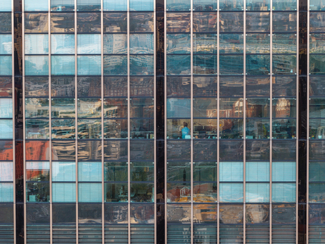 Aerial view of the glass facade of the Berlin Treptowers office building showing geometric window patterns and reflections of the surrounding urban environment in Berlin Berlin Germany. Aerial view of the glass facade of the Berlin Treptowers office building showing geometric window patterns and reflections of the surrounding urban environment in Berlin Berlin Germany.