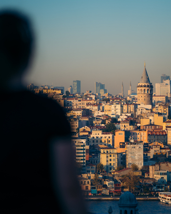 Istanbul Turkiye 03 October 2019 View of the Galata Tower piercing the skyline amidst a tapestry of warm toned buildings under a clear cool sky observed from afar.