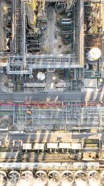 Aerial view of a petrochemical complex with complex pipe networks storage tanks and industrial cooling fans in Santo Andre State of Sao Paulo Brazil.