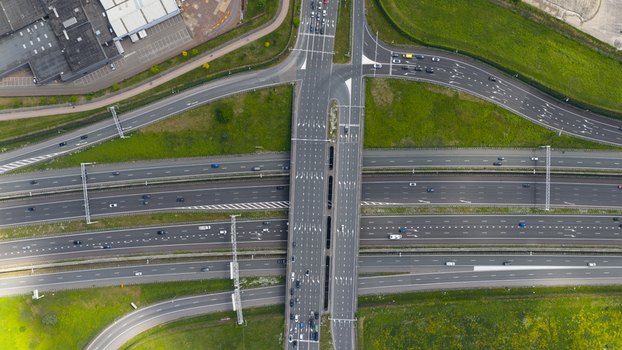Aerial view of Stadsbaan Leidsche Rijn highway interchange with multiple lanes moving traffic and green verges in Utrecht Utrecht Netherlands. Aerial view of Stadsbaan Leidsche Rijn highway interchange with multiple lanes moving traffic and green verges in Utrecht Utrecht Netherlands.