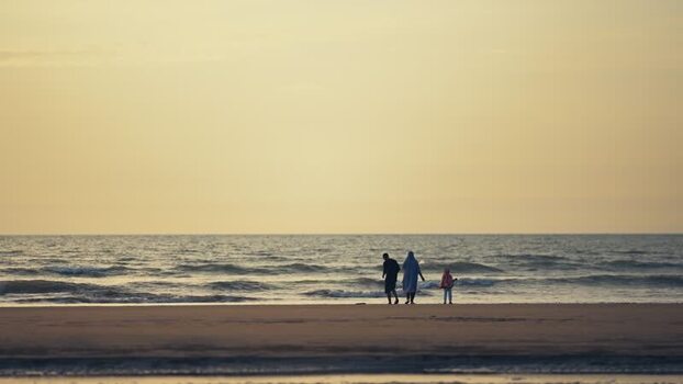 View of people walking on Cox s Bazar beach at sunset Bangladesh. View of people walking on Cox s Bazar beach at sunset Bangladesh.