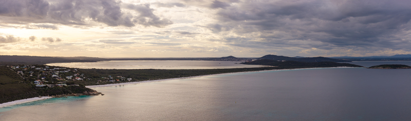 Aerial view of Frenchman Bay with its sandy coastline turquoise waters and surrounding residential area under a cloudy sky in Albany Western Australia Australia. Aerial view of Frenchman Bay with its sandy coastline turquoise waters and surrounding residential area under a cloudy sky in Albany Western Australia Australia.