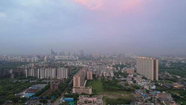 Aerial view of Gurugram cityscape at dusk in India.