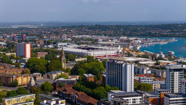 Aerial view of St Mary s Stadium surrounded by urban buildings green trees and the nearby marina in Southampton England United Kingdom. Aerial view of St Mary s Stadium surrounded by urban buildings green trees and the nearby marina in Southampton England United Kingdom.