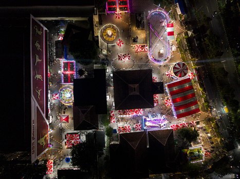 Aerial view of GOR Gelarsena Klaten Night Market with vibrant neon lights amusement rides and crowds of people at night Kecamatan Klaten Utara Jawa Tengah Indonesia. Aerial view of GOR Gelarsena Klaten Night Market with vibrant neon lights amusement rides and crowds of people at night Kecamatan Klaten Utara Jawa Tengah Indonesia.