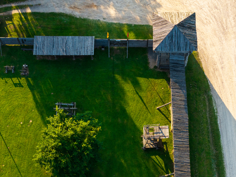 Aerial view of the wooden fortifications of Voruta castle with a watchtower defensive walls and green courtyard in Anyksciai Utenos apskritis Lithuania.