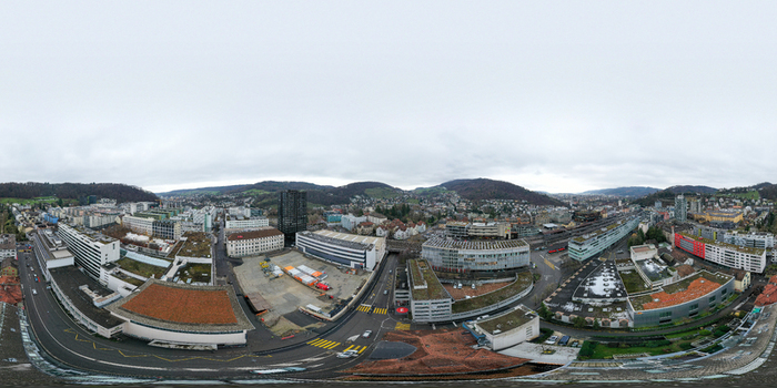 Aerial view of the ABB industrial complex and modern urban architecture surrounded by forested hills under an overcast sky in Baden Aargau Switzerland. Aerial view of the ABB industrial complex and modern urban architecture surrounded by forested hills under an overcast sky in Baden Aargau Switzerland.