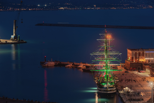 Ancona Italy 12 October 2022 Aerial view of the tall ship Amerigo Vespucci illuminated in green lights docked at the port of Ancona at night with harbor infrastructure and calm water visible. Ancona Italy 12 October 2022 Aerial view of the tall ship Amerigo Vespucci illuminated in green lights docked at the port of Ancona at night with harbor infrastructure and calm water visible.