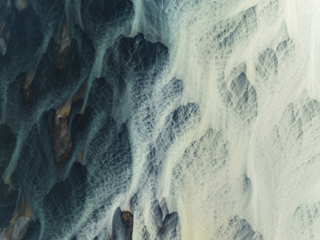 Aerial view of glacial rivers carve intricate paths through the stark contrasting landscape of Iceland where dark earth meets pale waters Iceland Iceland. Aerial view of glacial rivers carve intricate paths through the stark contrasting landscape of Iceland where dark earth meets pale waters Iceland Iceland.