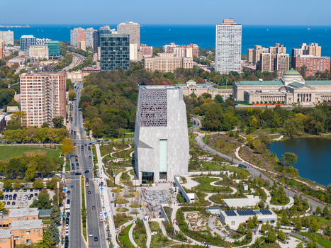 Aerial view of The Obama Presidential Center surrounded by parkland winding paths and modern architecture with Lake Michigan in the background in Chicago Illinois United States. Aerial view of The Obama Presidential Center surrounded by parkland winding paths and modern architecture with Lake Michigan in the background in Chicago Illinois United States.