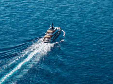 Aerial view of a luxury yacht cruising on the deep blue Mediterranean sea leaving a white wake near Le Trayas Saint Raphael Provence Alpes Cote d Azur France. Aerial view of a luxury yacht cruising on the deep blue Mediterranean sea leaving a white wake near Le Trayas Saint Raphael Provence Alpes Cote d Azur France.