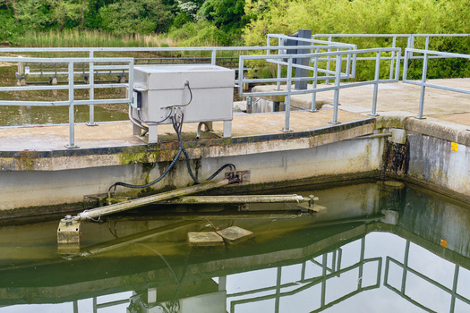 Wieringerwerf Netherlands 17 May 2026 View of the Gemaal Leemans pumping station with metal railings and concrete structures surrounded by lush green trees.